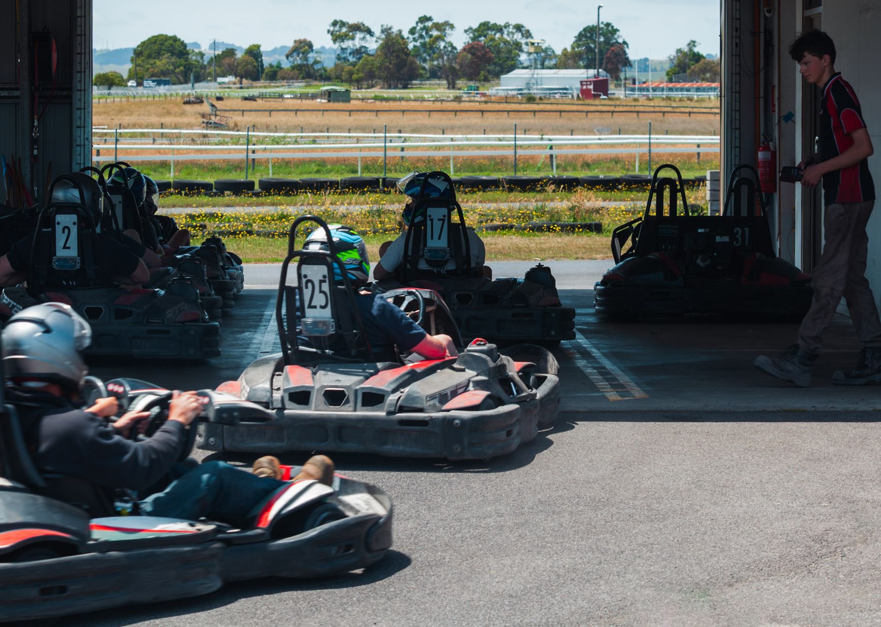 Hire karts rolling out of the kart shed onto the track