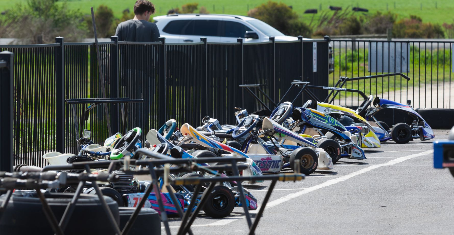 Race karts lined up on stands in the pit area